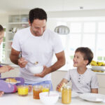 Family Eating Breakfast In Kitchen Together